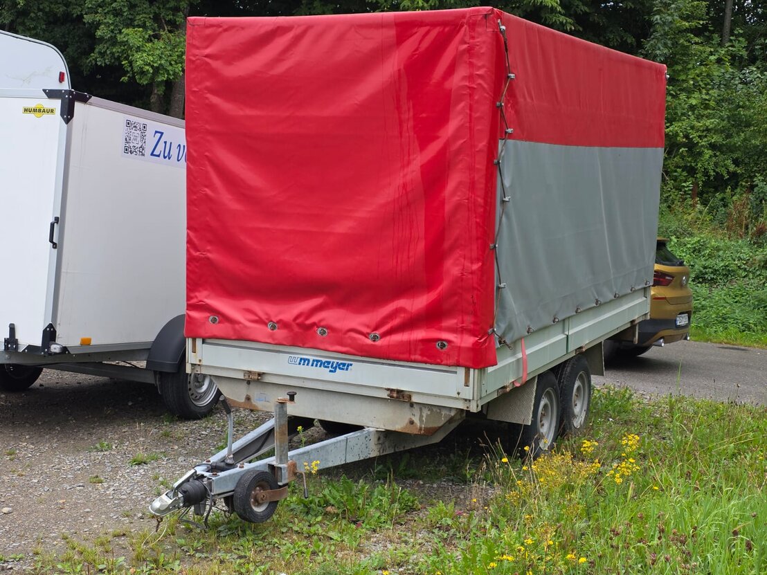 Planenanhänger mit blauem Planenaufbau